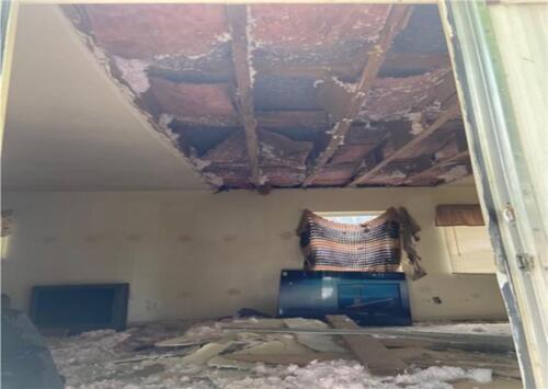 A room with a ceiling that has been damaged.