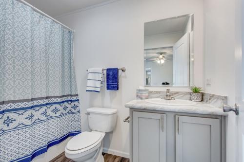 A bathroom with a blue and white shower curtain.